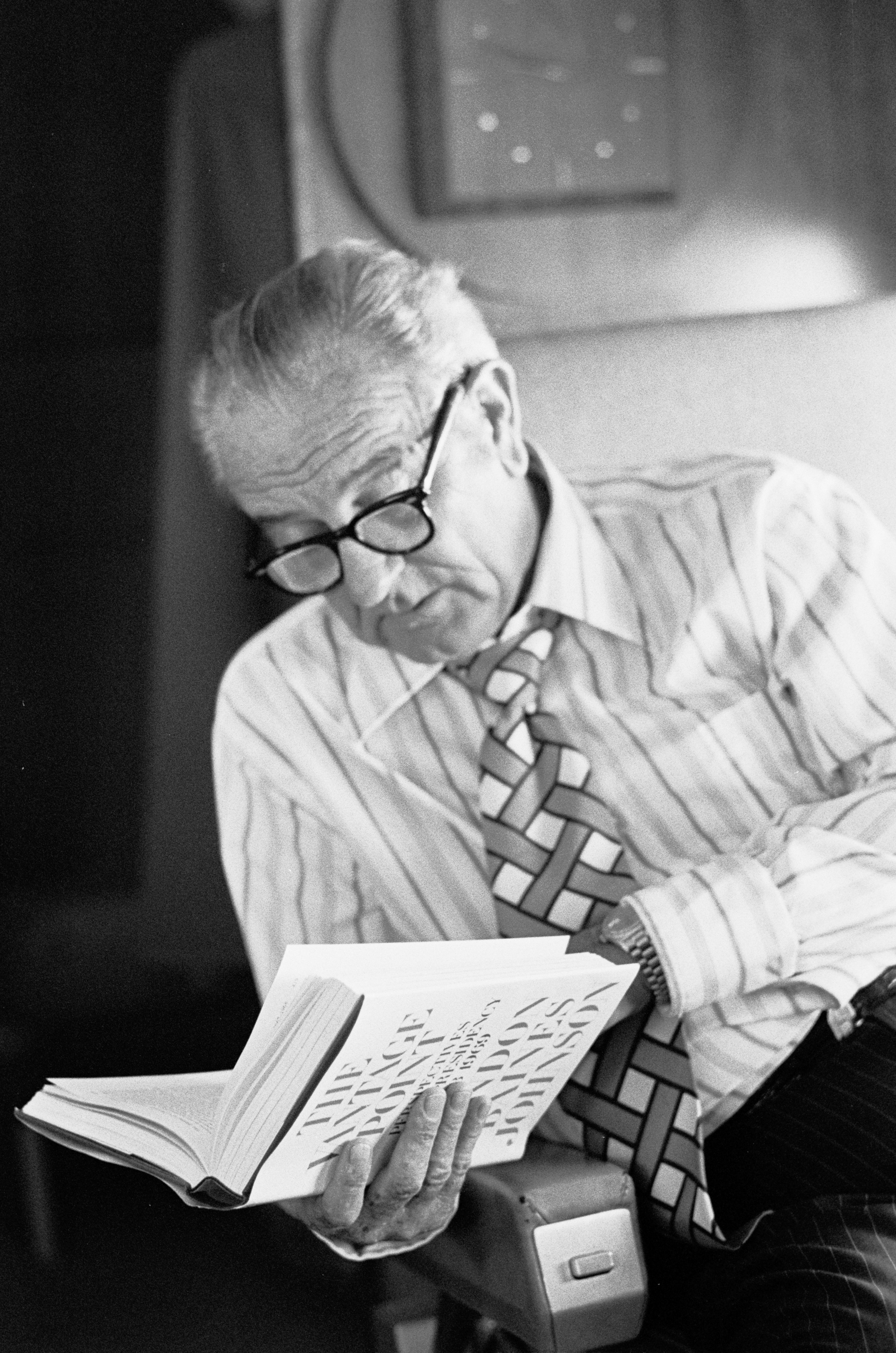 LBJ, with glasses, looks over his published memoir, "The Vantage Point."